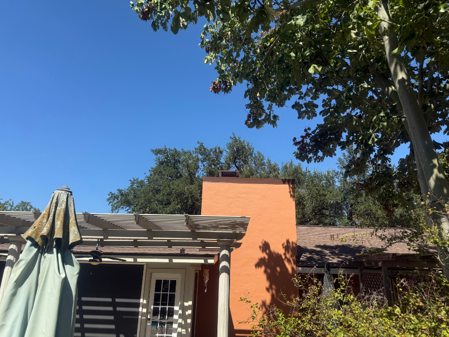 Black chimney cap on a steep roof